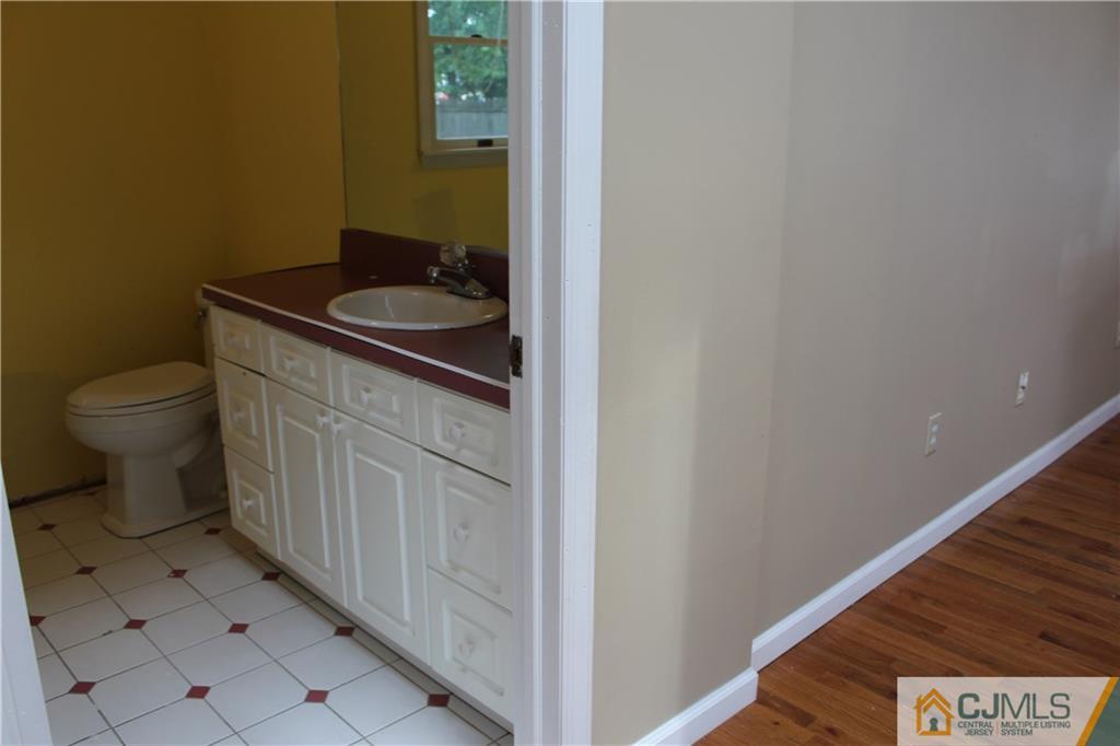 14 Kenmore Road Edison, NJ 08817 - Photo 15 of 21 a bathroom with a sink and a toilet