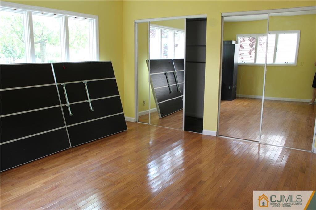 14 Kenmore Road Edison, NJ 08817 - Photo 17 of 21 a view of empty room with wooden floor and windows