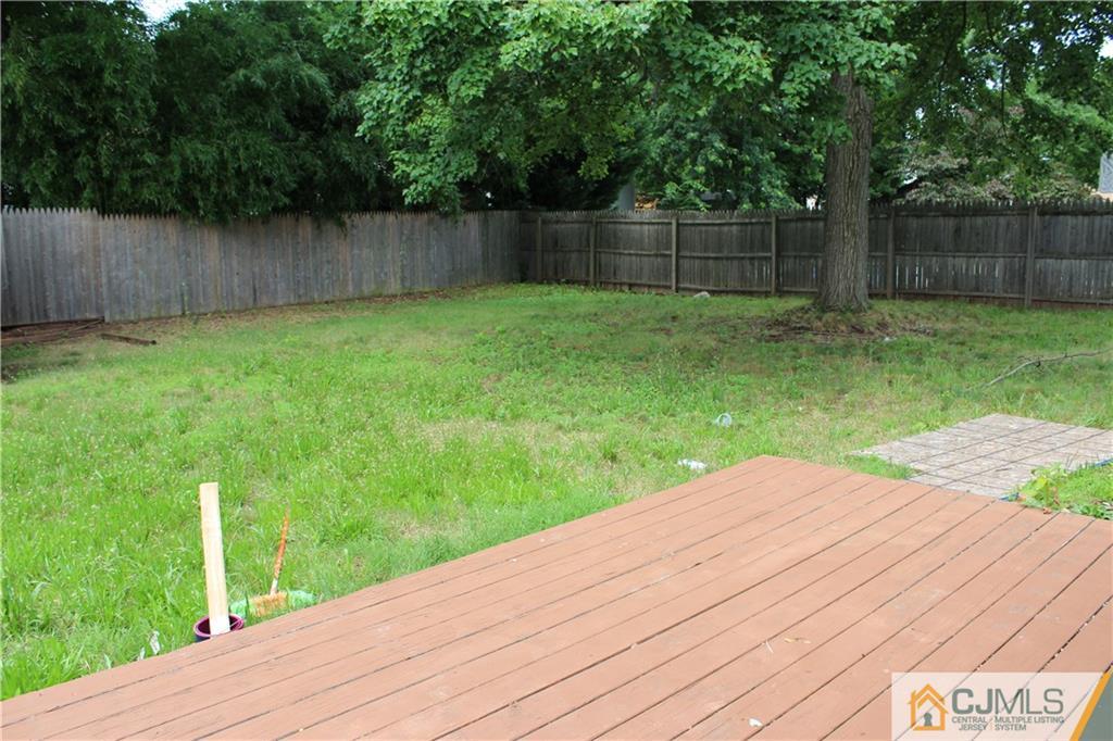 14 Kenmore Road Edison, NJ 08817 - Photo 20 of 21 a view of a backyard with a wooden fence