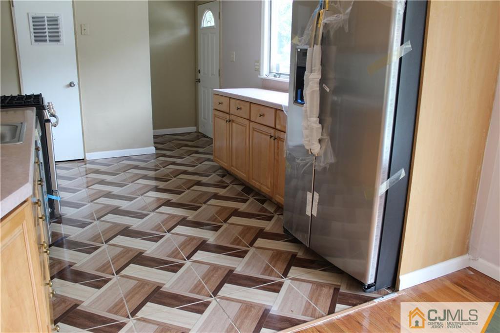 14 Kenmore Road Edison, NJ 08817 - Photo 21 of 21 a kitchen with a refrigerator and a stove