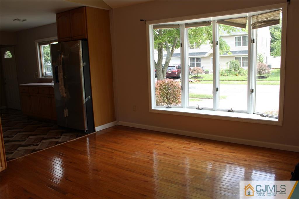 14 Kenmore Road Edison, NJ 08817 - Photo 6 of 21 a view of an empty room with wooden floor and a window