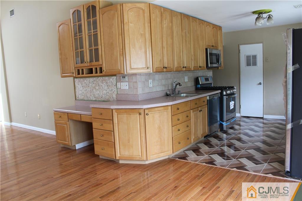14 Kenmore Road Edison, NJ 08817 - Photo 7 of 21 a kitchen with stainless steel appliances granite countertop a stove a sink and a microwave