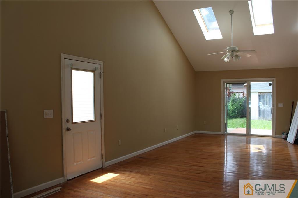 14 Kenmore Road Edison, NJ 08817 - Photo 10 of 21 a view of an empty room with wooden floor and a window