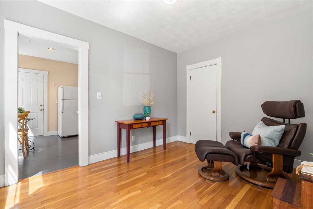 52 Lewis Avenue Arlington, MA 02474 - Photo 22 of 40 a workspace with furniture and wooden floor