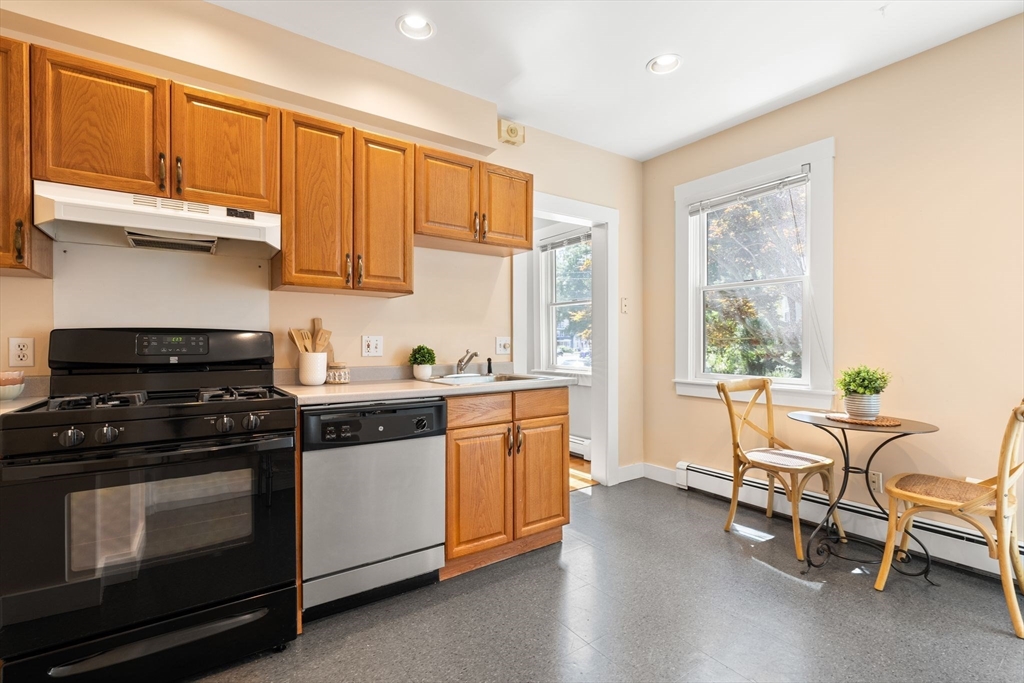 52 Lewis Avenue Arlington, MA 02474 - Photo 26 of 40 a kitchen with stainless steel appliances a stove a sink and white cabinets