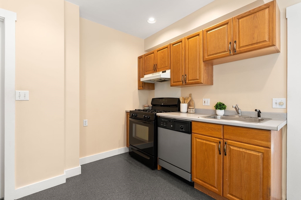 52 Lewis Avenue Arlington, MA 02474 - Photo 27 of 40 a kitchen with stainless steel appliances granite countertop a sink and a stove