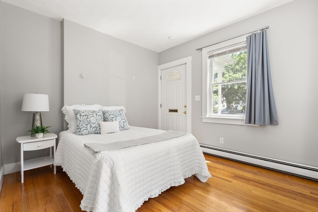 52 Lewis Avenue Arlington, MA 02474 - Photo 28 of 40 a bedroom with a bed and a lamp on table