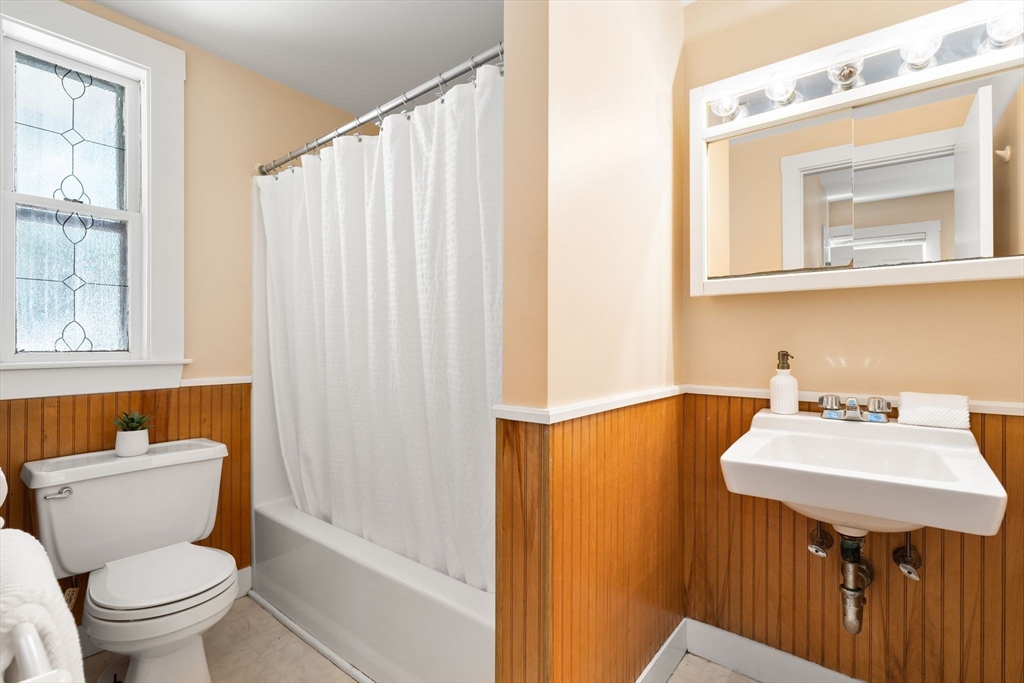 52 Lewis Avenue Arlington, MA 02474 - Photo 30 of 40 a bathroom with a sink mirror toilet and bathtub