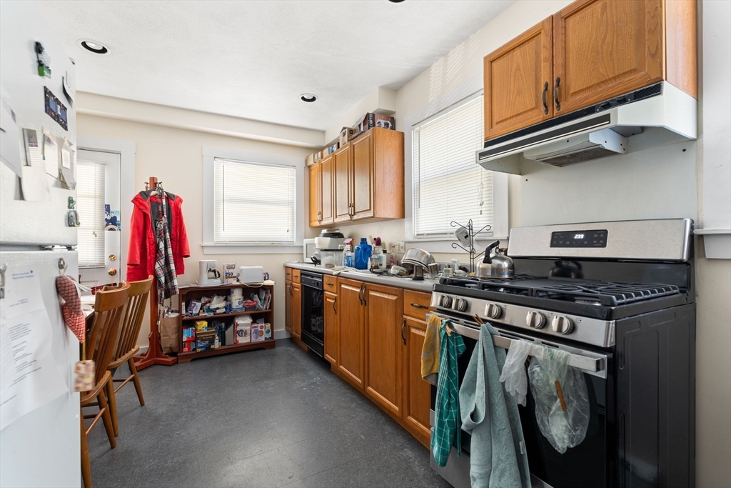 52 Lewis Avenue Arlington, MA 02474 - Photo 32 of 40 a kitchen with stainless steel appliances granite countertop a stove and a sink