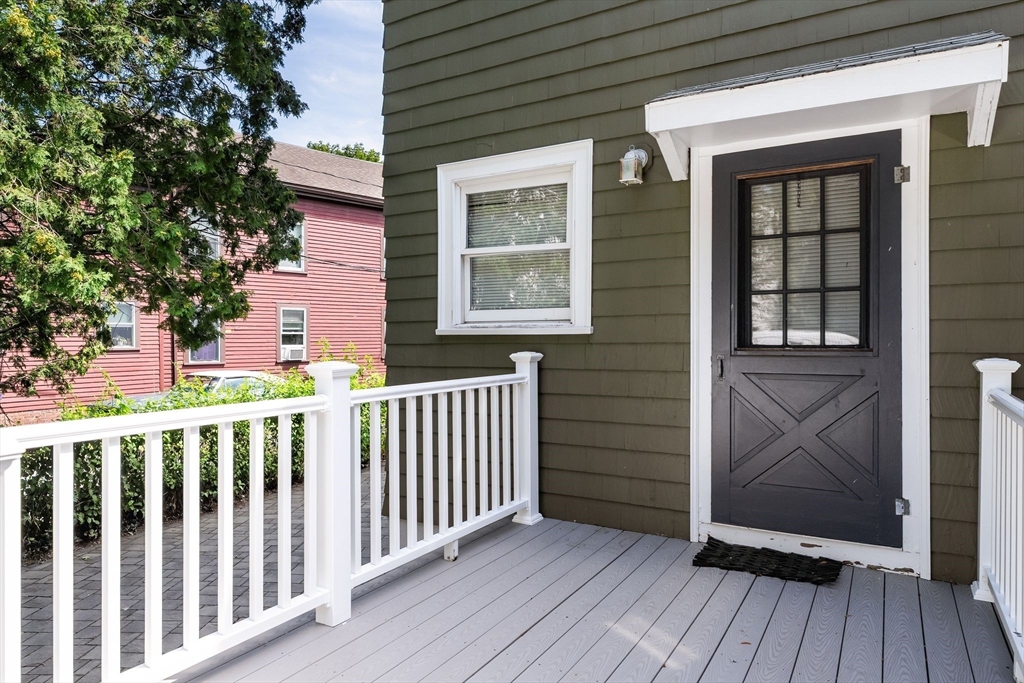 52 Lewis Avenue Arlington, MA 02474 - Photo 34 of 40 a view of a porch with wooden floor and fence