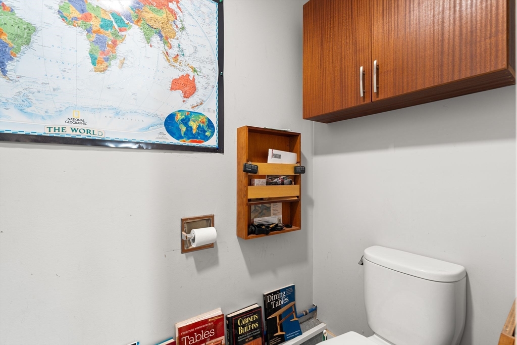 52 Lewis Avenue Arlington, MA 02474 - Photo 39 of 40 a bathroom with a toilet and a shower curtain