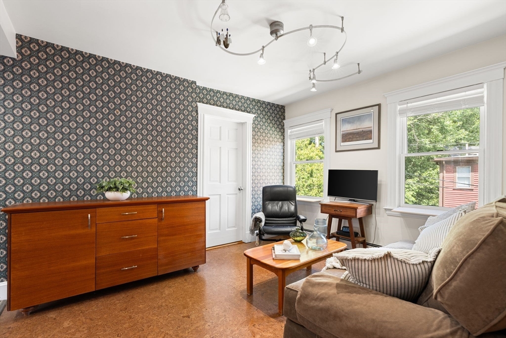 52 Lewis Avenue Arlington, MA 02474 - Photo 6 of 40 a living room with furniture a large window and a flat screen tv