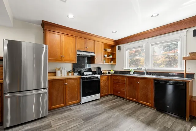 a kitchen with stainless steel appliances granite countertop a refrigerator stove microwave and sink