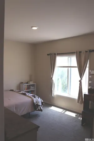 a view of a dry yard with wooden fence