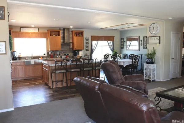 a living room with fireplace furniture and a large window
