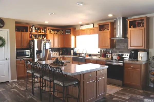 a kitchen with a sink refrigerator and cabinets