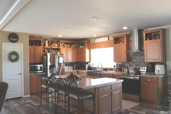 a kitchen with granite countertop a sink counter top space and stainless steel appliances