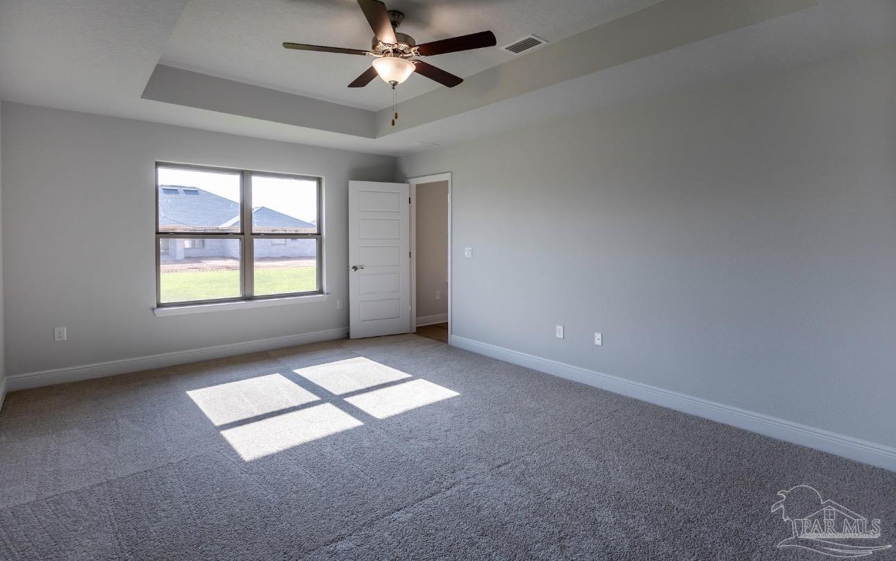 7645 Small Pnes Street Milton, FL 32583 - Photo 4 of 5 an empty room with windows and fan