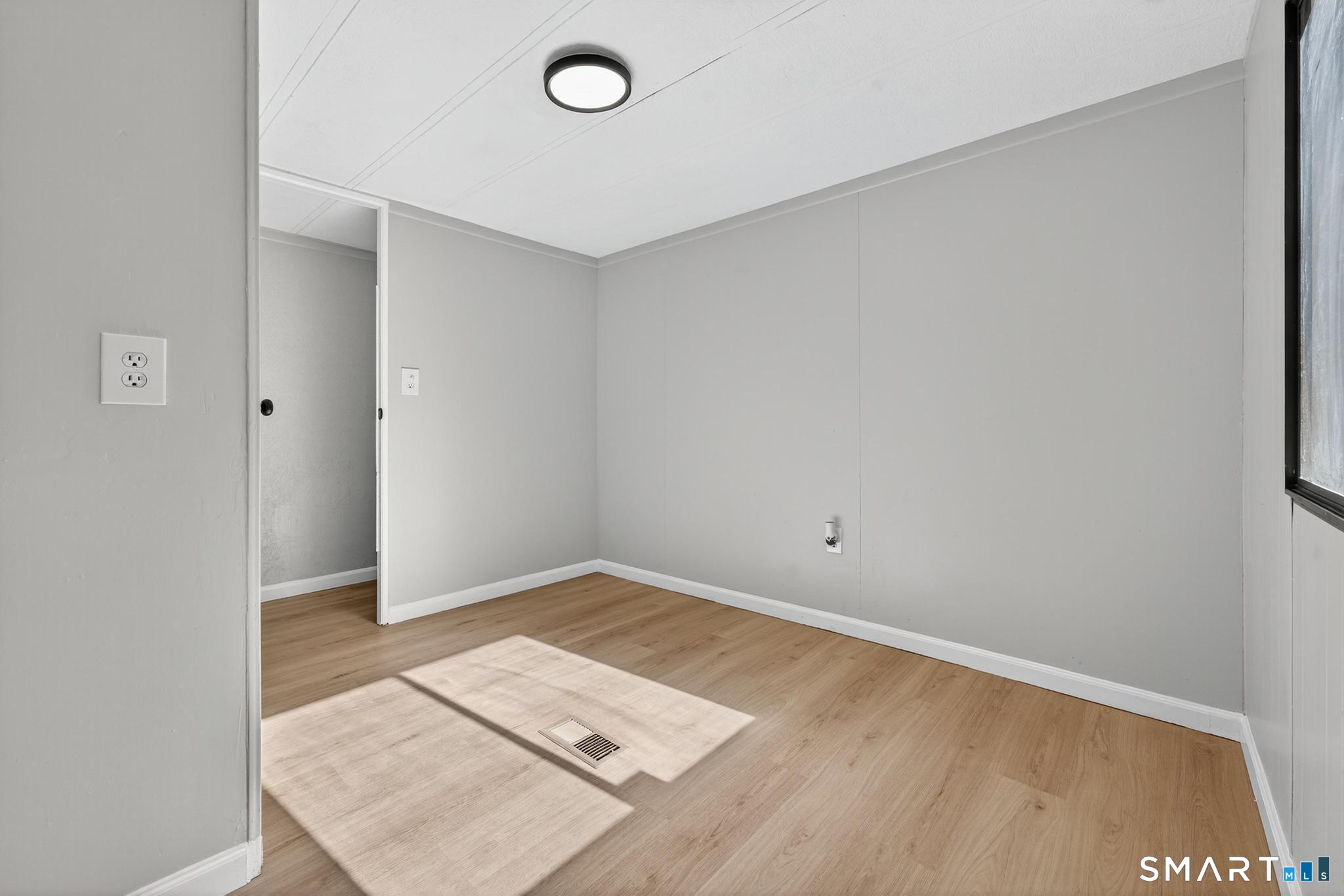 32 Nashua Street Norwich, CT 06360 - Photo 12 of 19 an empty room with wooden floor