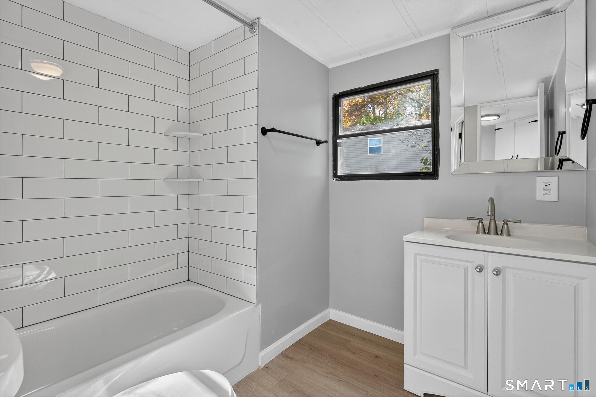 32 Nashua Street Norwich, CT 06360 - Photo 15 of 19 a bathroom with a bathtub and sink