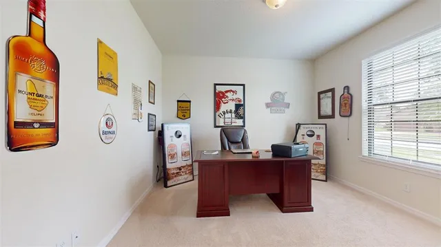 a view of a workspace with furniture and a window