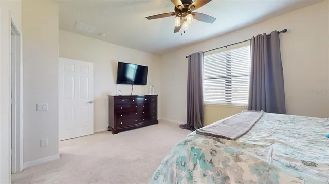 an aerial view of residential houses with outdoor space and lake view
