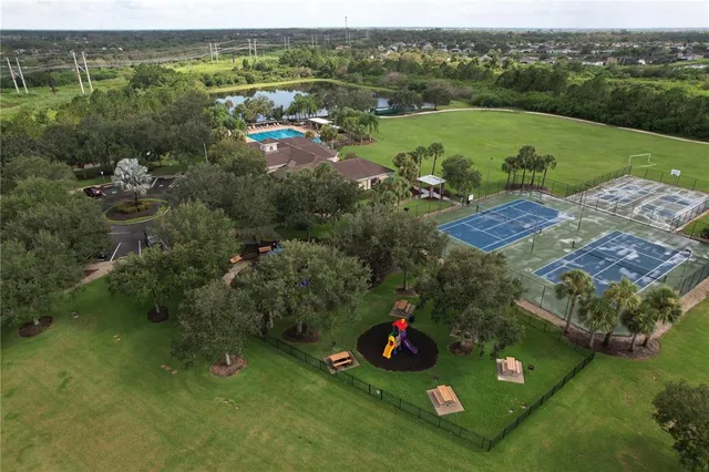 an aerial view of a house with pool lake view and mountain view
