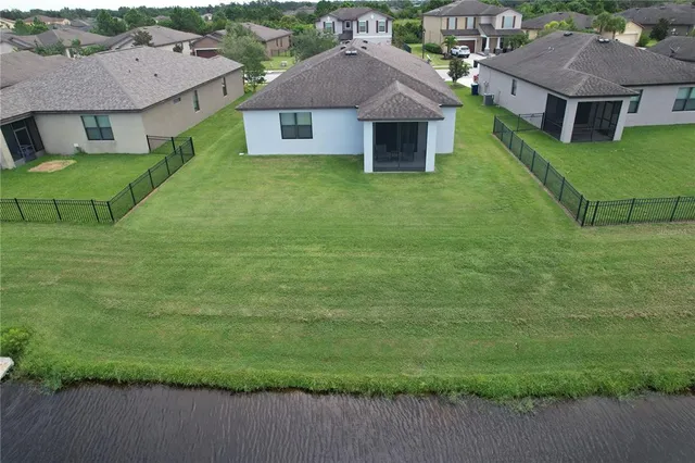 a front view of a house with a garden and yard