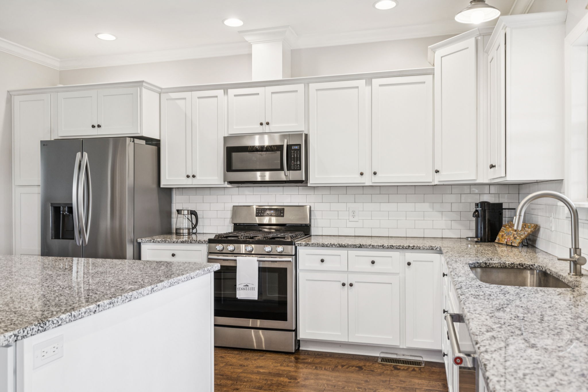 1361 Neil Road Chapel Hill, TN 37034 - Photo 7 of 24 a kitchen with granite countertop a sink stainless steel appliances and white cabinets