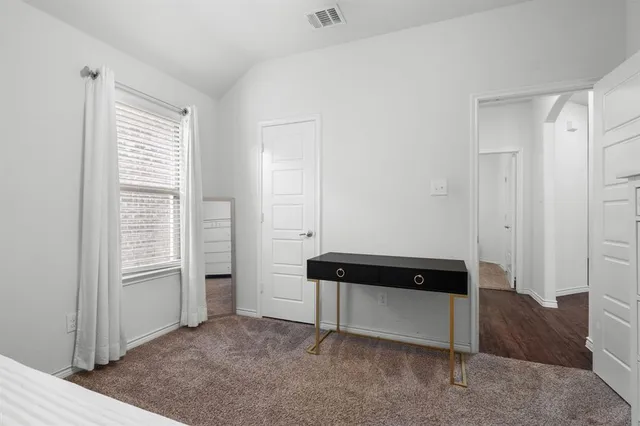 a view of bedroom with furniture and windows