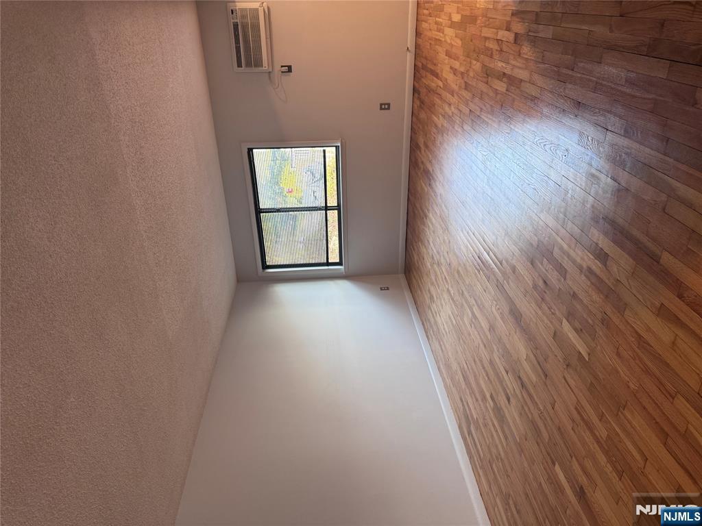 148 Undercliff Avenue, Unit 4 Edgewater, NJ 07020 - Photo 2 of 6 an empty room with wooden floor and windows