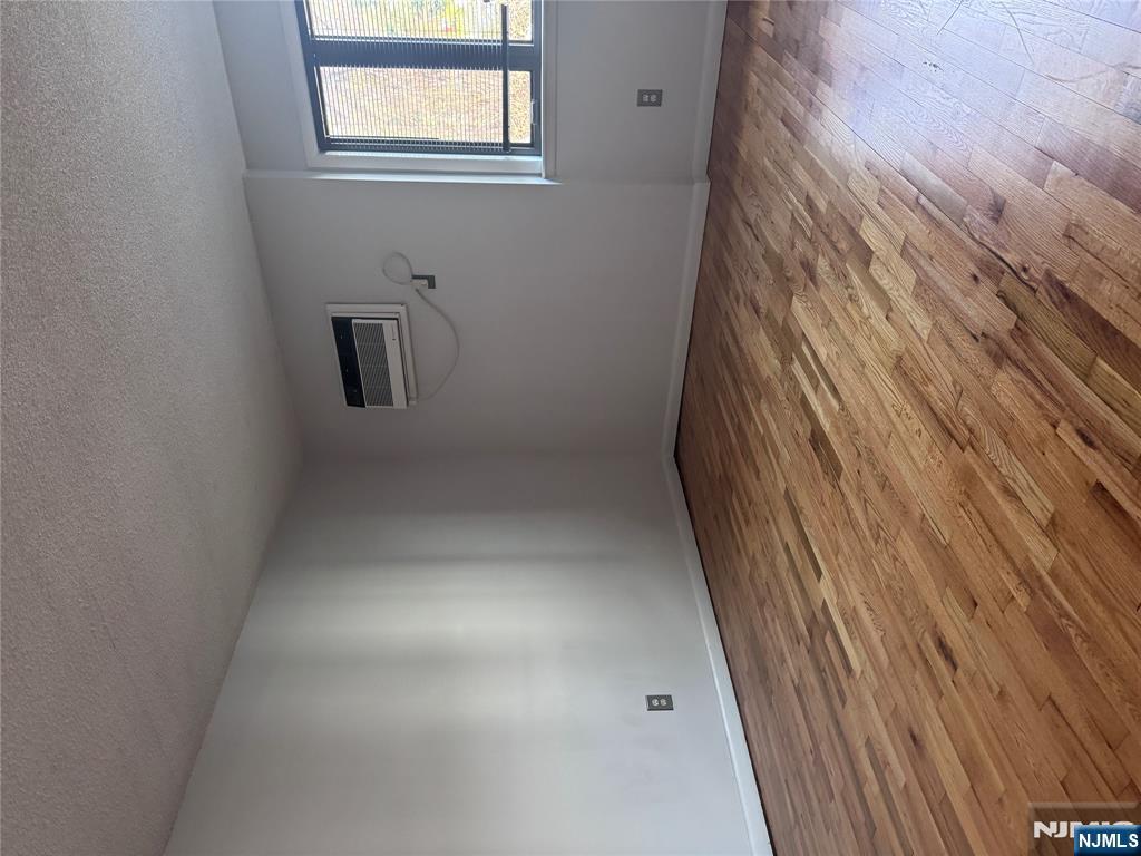 148 Undercliff Avenue, Unit 4 Edgewater, NJ 07020 - Photo 3 of 6 a view of an empty room with wooden floor and a window