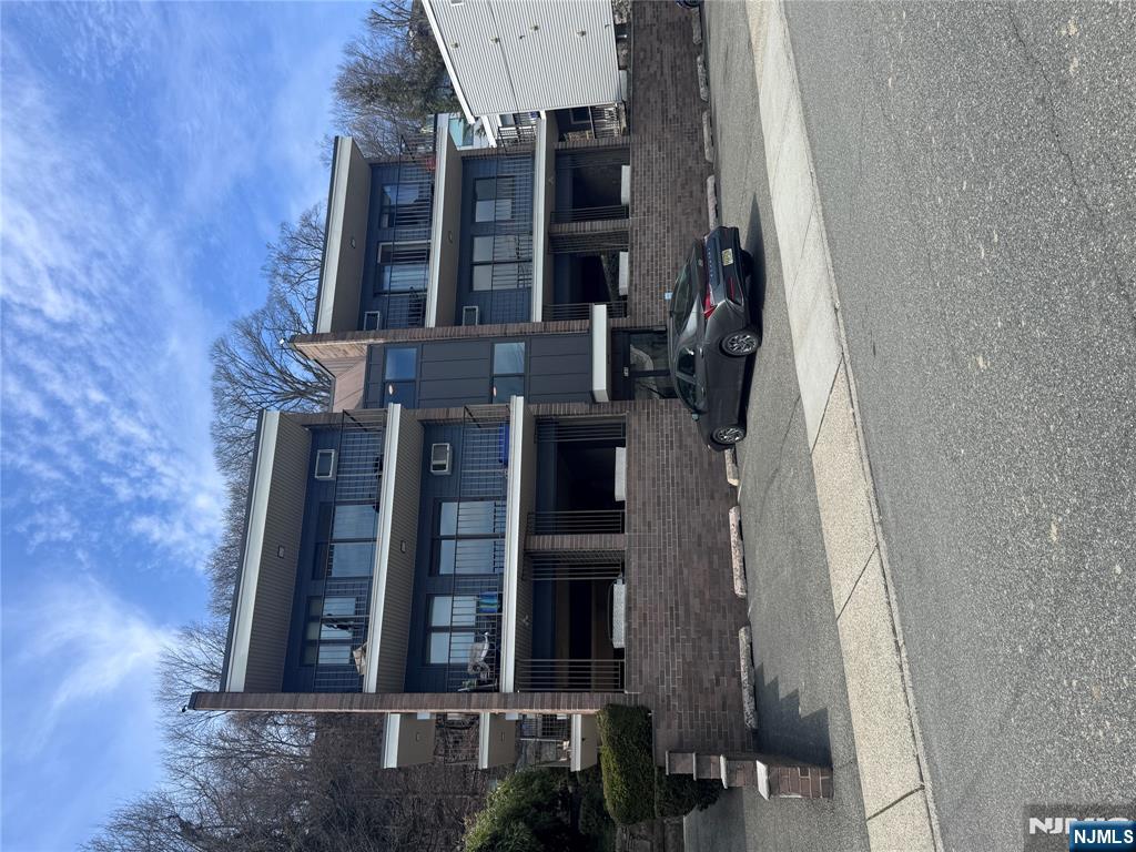 148 Undercliff Avenue, Unit 4 Edgewater, NJ 07020 - Photo 5 of 6 a front view of a house with a yard