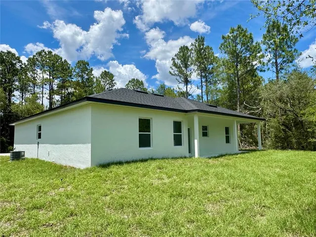 a backyard of a house with lots of green space