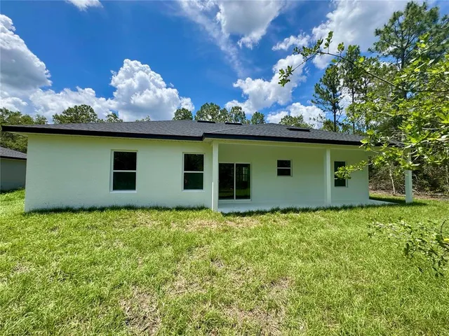 a outdoor view of a house with a big yard