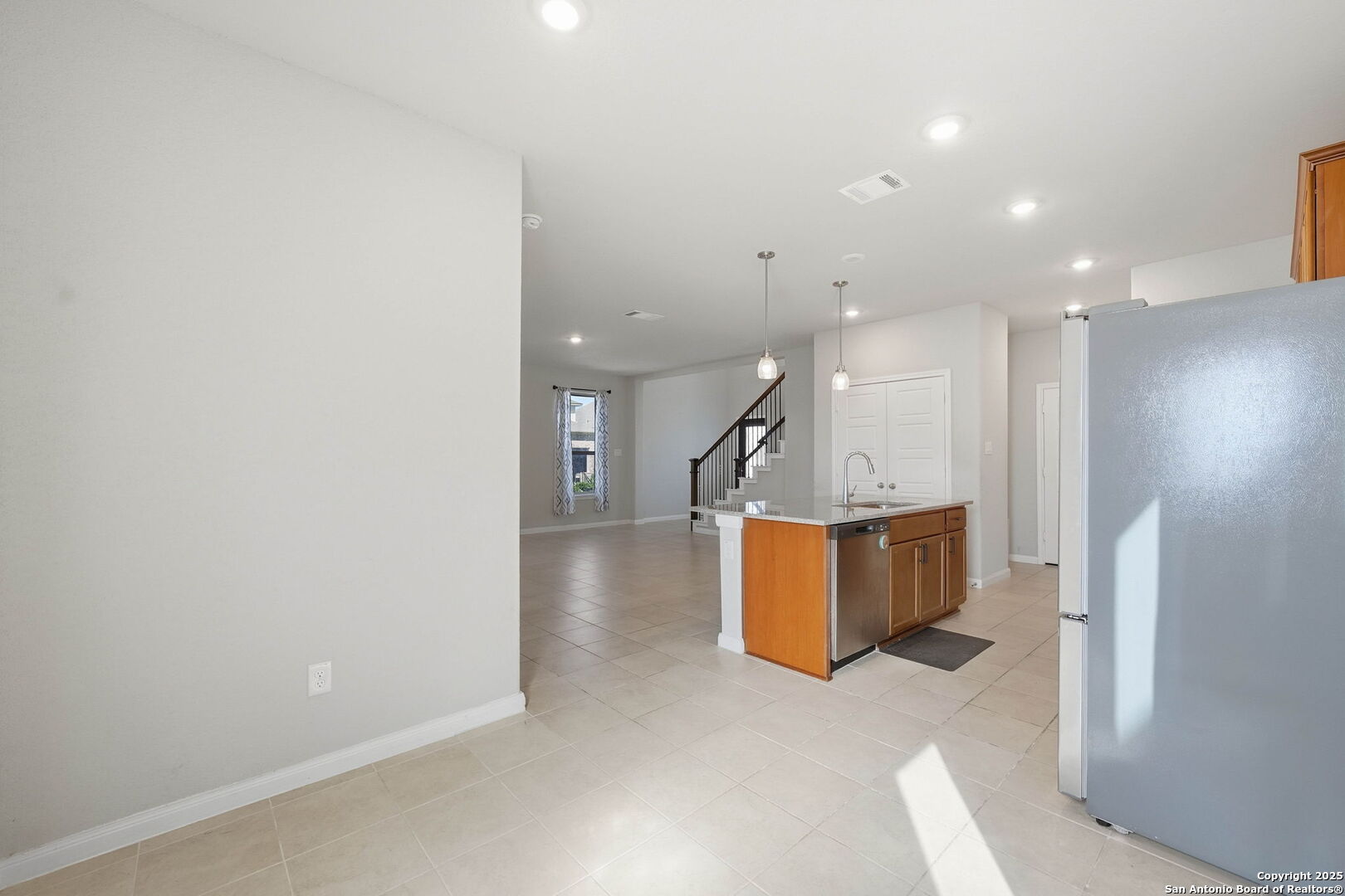 9102 Devils River Converse, TX 78109 - Photo 12 of 34 an empty room with wooden floor and a ceiling fan