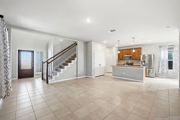 a large white kitchen with a sink and cabinets