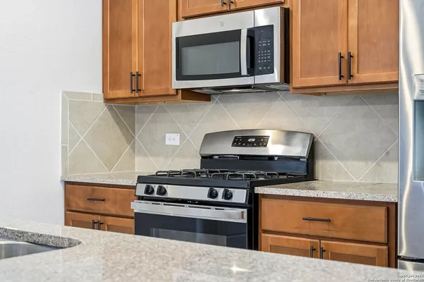 a kitchen with refrigerator cabinets and microwave