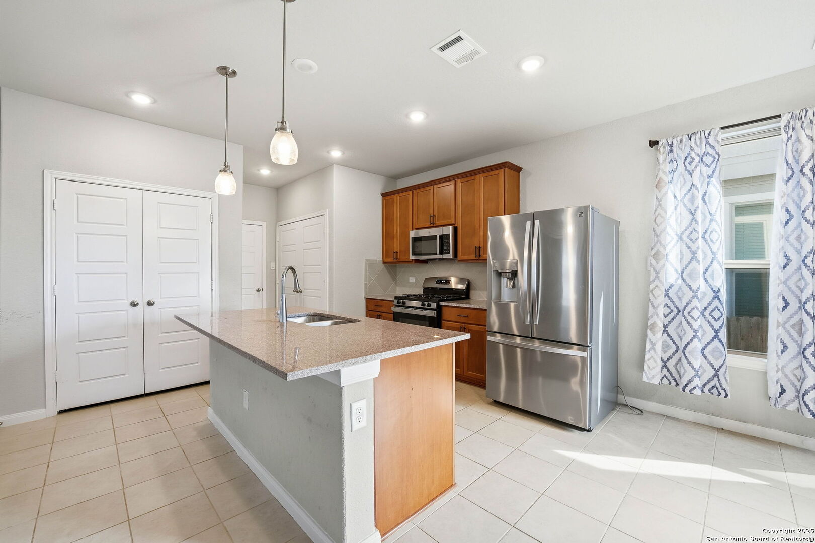 9102 Devils River Converse, TX 78109 - Photo 9 of 34 a kitchen with refrigerator cabinets and microwave