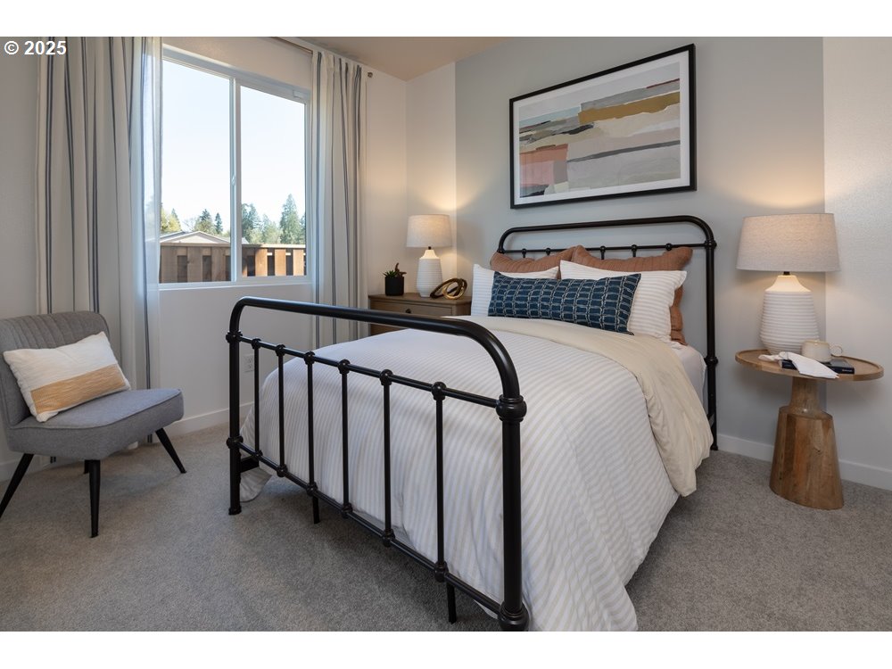 436 Southwest 32nd Street Battle Ground, WA 98604 - Photo 11 of 14 a bedroom with a bed a mirror and a large window