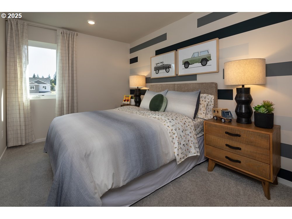 436 Southwest 32nd Street Battle Ground, WA 98604 - Photo 5 of 14 a bedroom with a bed a mirror and lamp