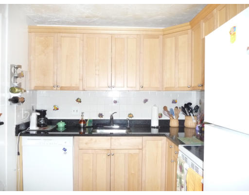 15 Weld Street, Unit 46 Framingham, MA 01702 - Photo 4 of 11 a kitchen with stainless steel appliances granite countertop a sink a stove and white cabinets