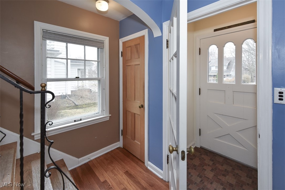 2469 Queenston Road Cleveland, OH 44118 - Photo 3 of 37 Foyer entrance with wood finished floors, baseboards, and arched walkways