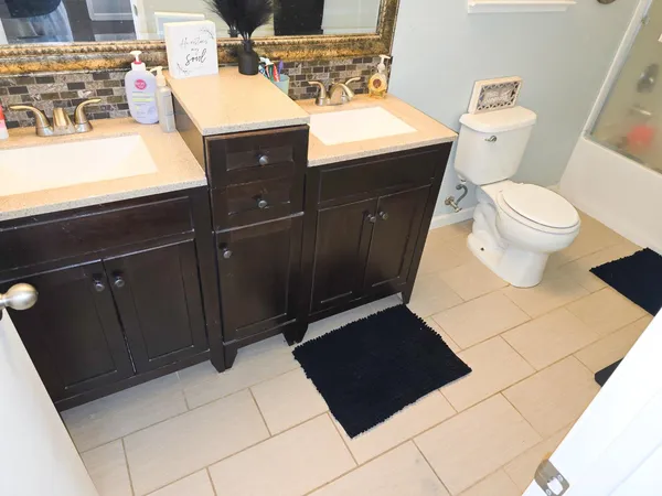 a bathroom with a sink a toilet a vanity and mirror