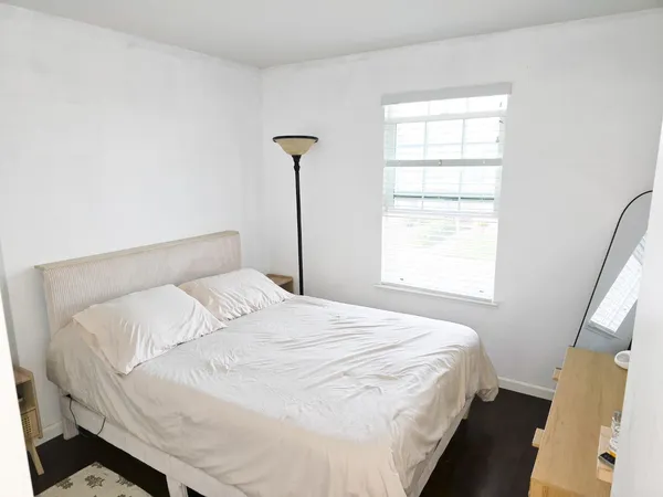 a bedroom with a bed and a window