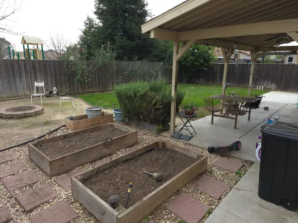 a view of a backyard with sitting area furniture and garden