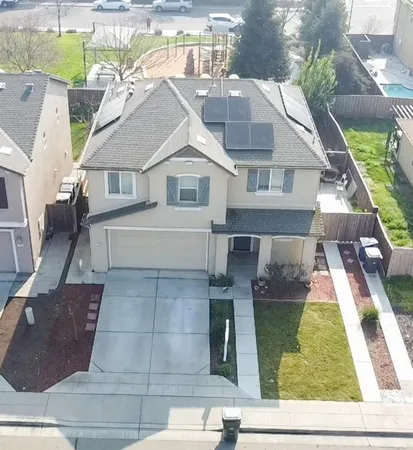 an aerial view of a house with swimming pool