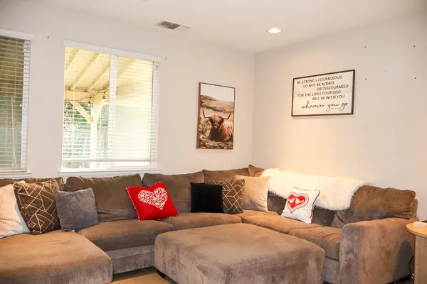 a living room with furniture and a large window