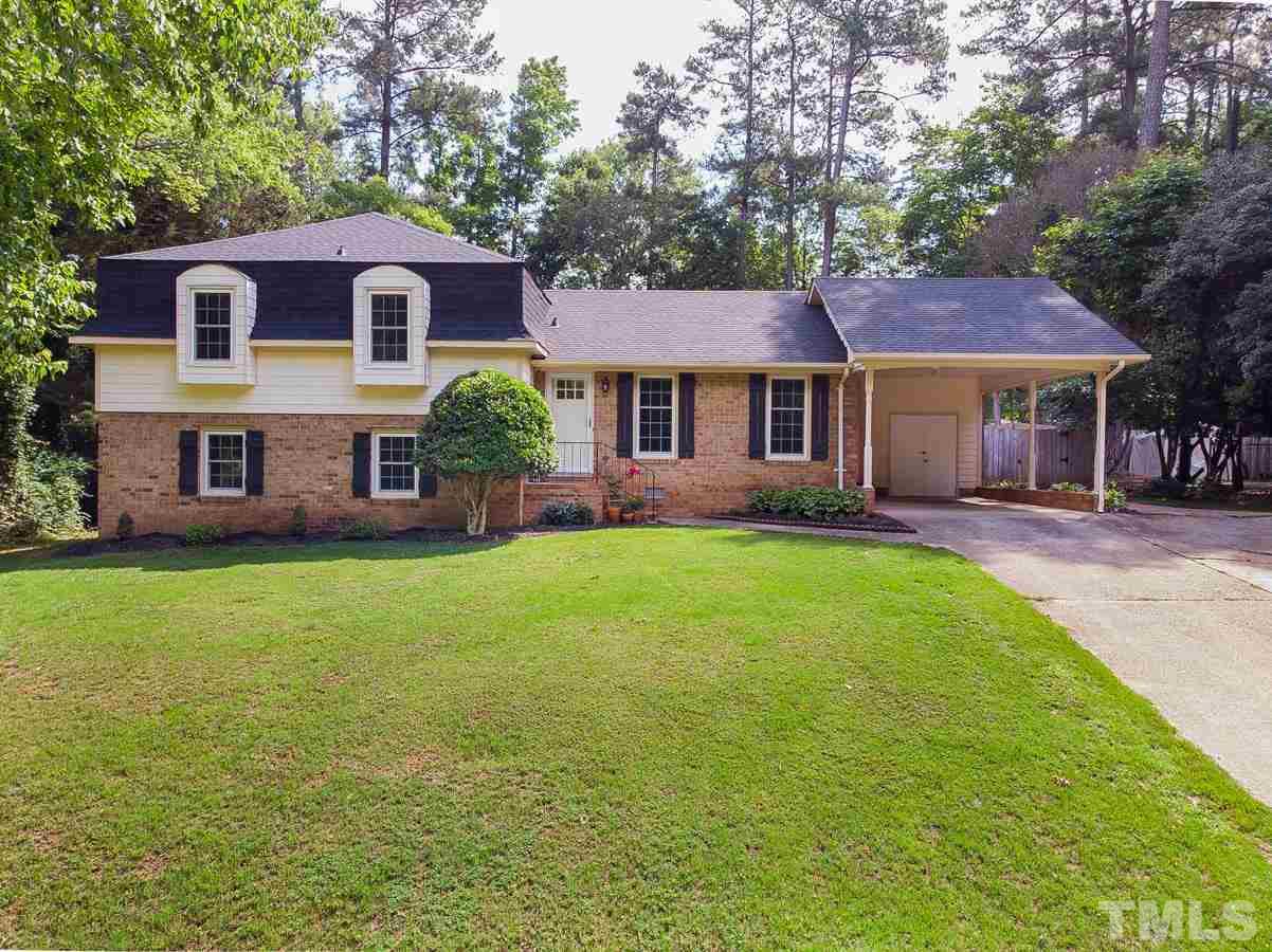 4208 Pickwick Drive Raleigh, NC 27613 - Photo 1 of 25 a front view of a house with a garden and porch