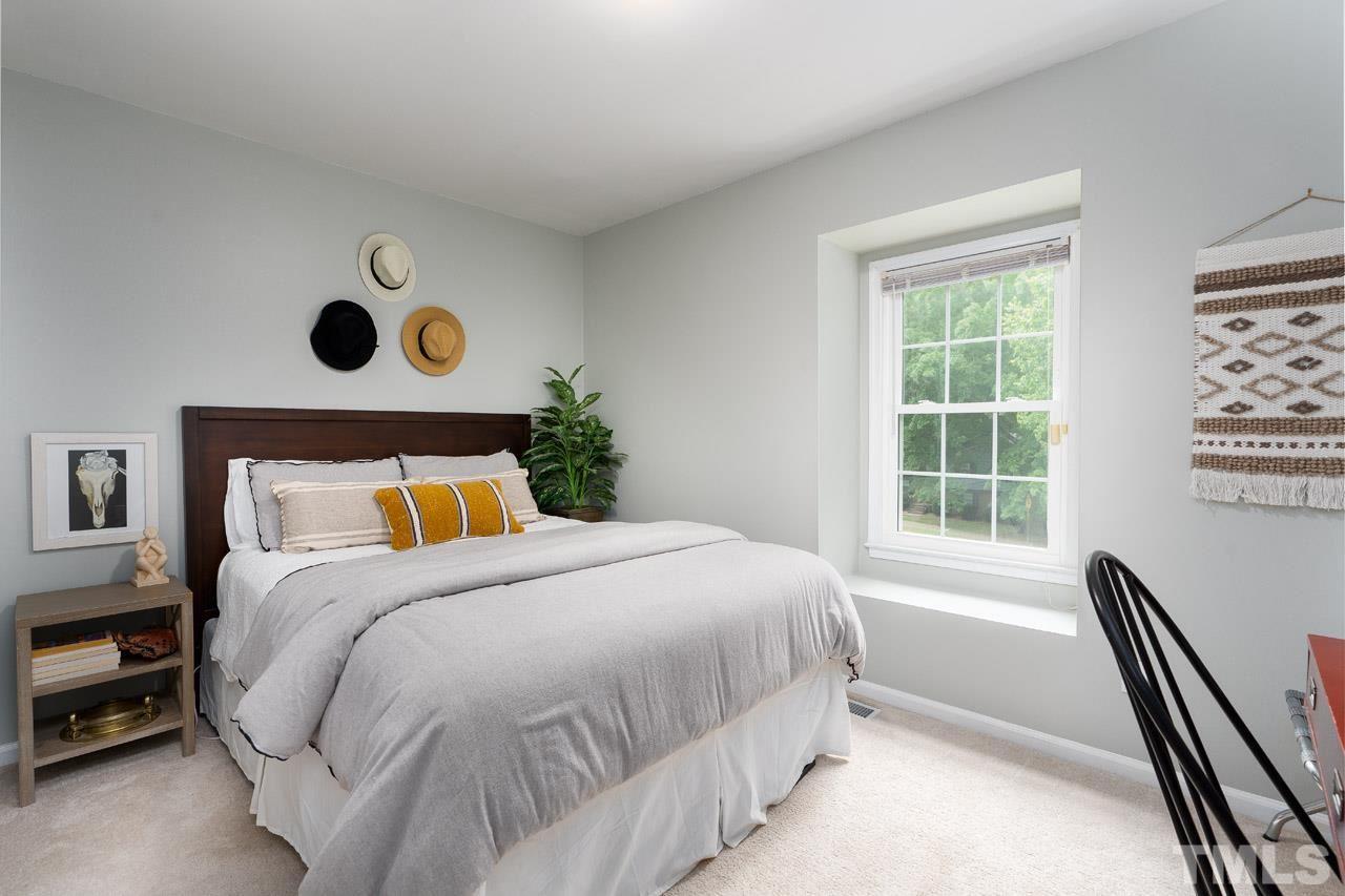 4208 Pickwick Drive Raleigh, NC 27613 - Photo 14 of 25 a bedroom with a bed and a window